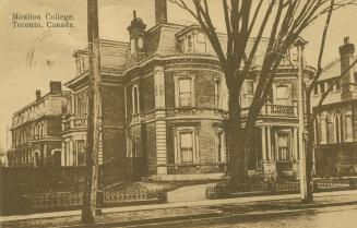 Sepia toned picture of the front of a large, three story house in a Victorian style.