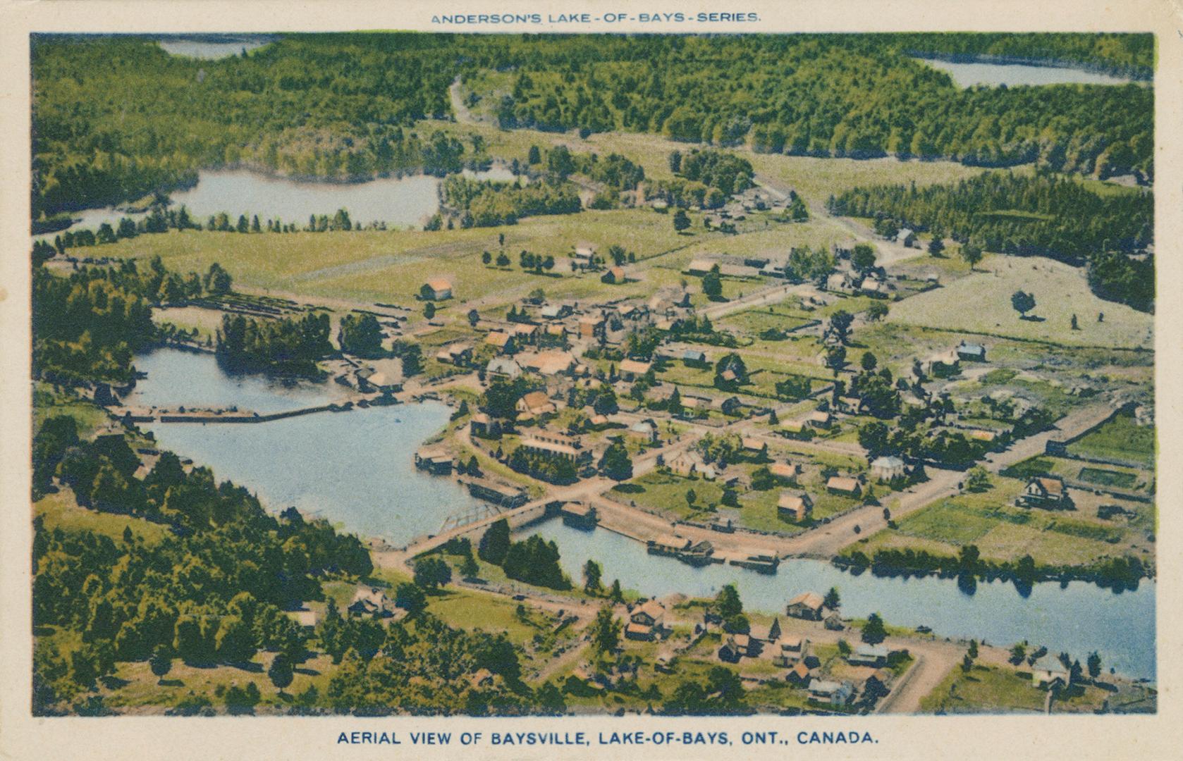 Aerial view of rural town with river and lakes and trees.