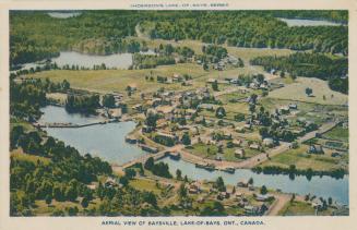 Aerial view of rural town with river and lakes and trees.