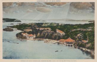 Bird's eye view of lake and an island with large hotel buildings. 