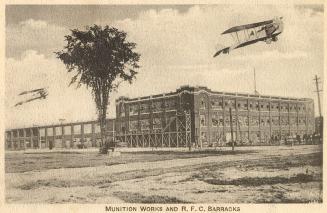 Picture shows two airplanes flying over a large factory complex.
