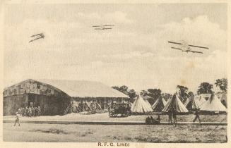 Picture shows airplanes flying over military tents.