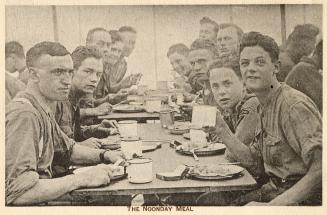 Sepia toned picture of air force cadets sitting at wooden tables eating and drinking.