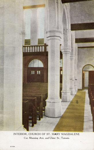 Church interior with large pillars and arches and rows of pews. 