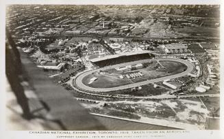 Aerial shot of large track and grand stand in exhibition grounds. B & W.