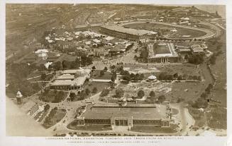 Aerial shot of large of large buildings and track in exhibition grounds. B & W.