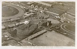 Aerial shot of large of large buildings and roller coaster in exhibition grounds. B & W.