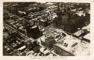 Aerial shot of a large city with tall buildings and Old City Hall. Black and white.