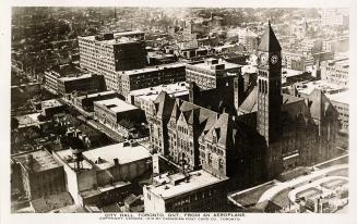 Aerial shot of a large city with tall buildings and a Richardsonian Romanesque structure in the ...