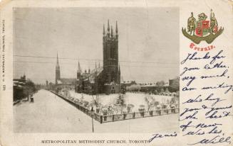 Picture of street scene with large church in the snow.