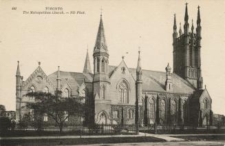 View of cathedral church surrounded by iron fence. 