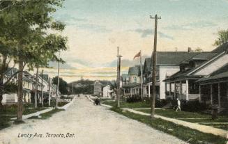 Picture of a wide street with sidewalks and houses on both sides. 