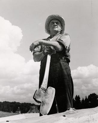 Black and white photograph of Charles Hummel with axe