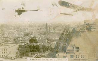 Black and white photograph of two airplanes flying over a large city.