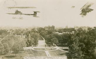 Black and white photograph of two airplanes flying over a park.