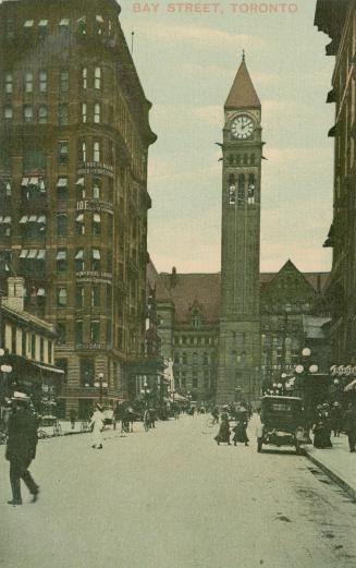Colorized photograph of a busy city street with a large public building with a clock tower at t ...
