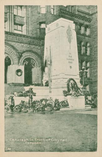 Black and white photograph of a tall, square stone monument with wreaths placed at it's base.