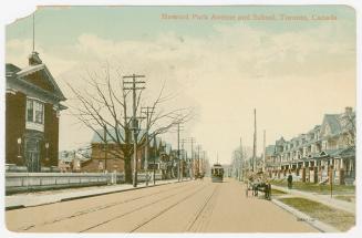 Picture of a street with houses on right and school on left side and streetcar tracks and stree ...