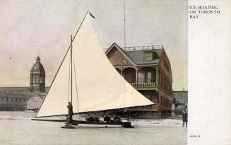 Colorized picture of an ice boats on a frozen lake in front of two buildings.