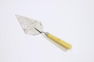 A silver trowel with a bone handle.