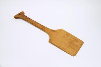A small wooden, flat shovel.
