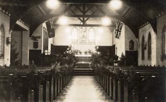 Picture of interior of a church shows altar and pews. 
