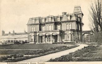 Black and white photograph of a huge, three story residential home in the Second Empire style.
