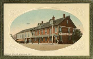 Colorized photograph of a row of houses on a town street.