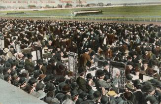 Picture of a large crowd in betting ring at a racetrack.