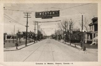 Black and white picture of a suburban street with a banner "Weston" strung across it.