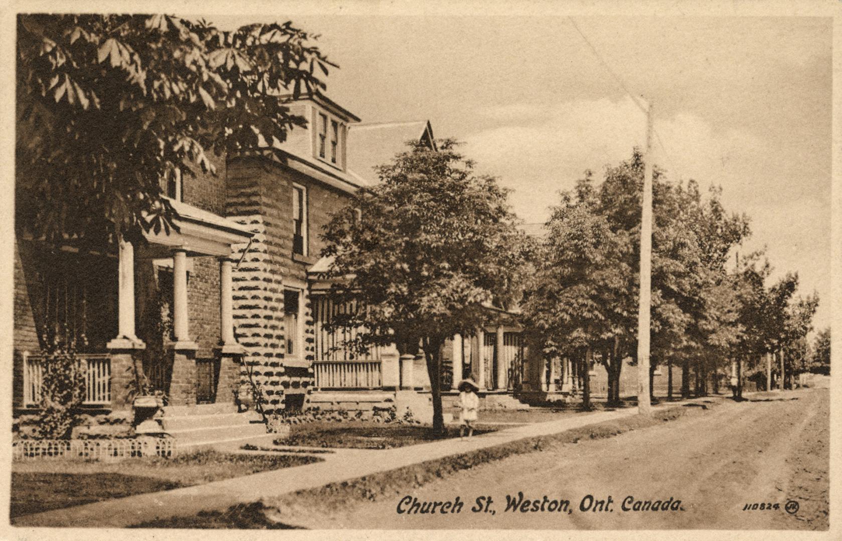 Sepia toned photograph of a city street in a residential area.