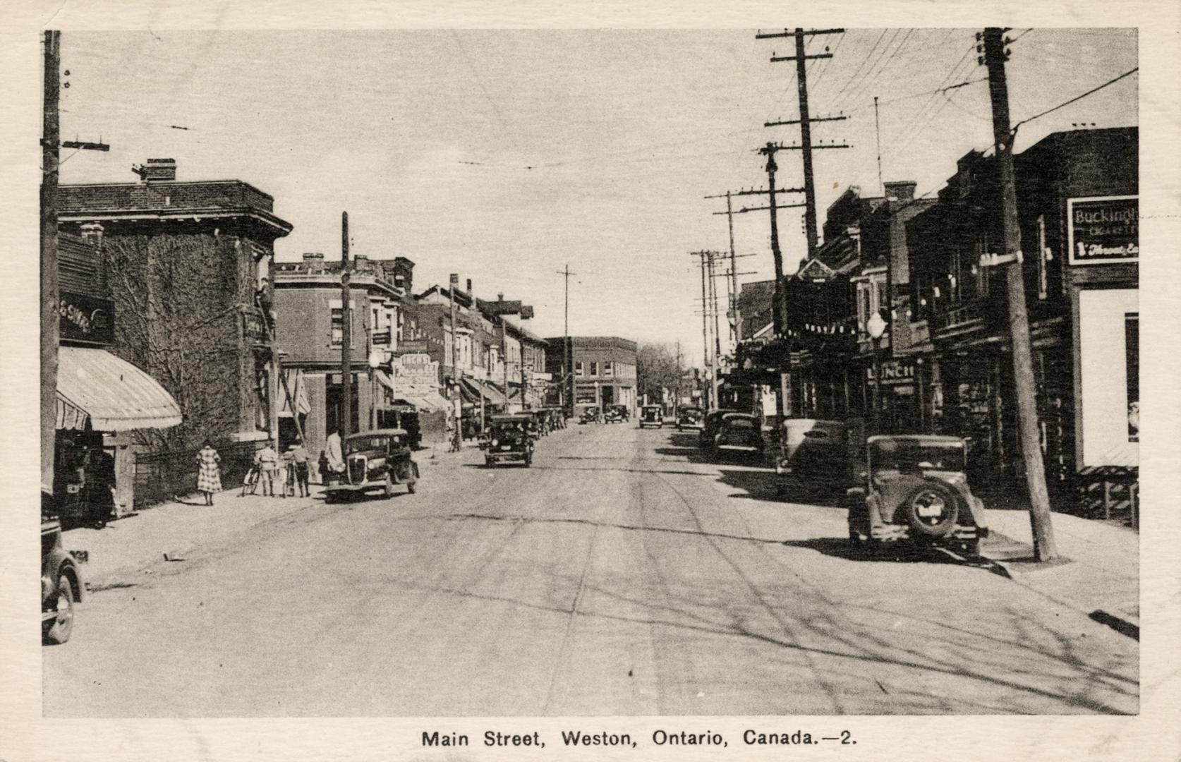 Black and white picture of a small town business street.