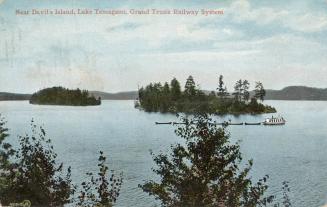 Colorized photograph of a lake in the wilderness with islands in it. Steamboat is pulling small…
