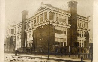 Black and white photograph of a three story school building.