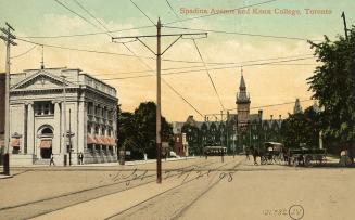 Colorized picture of a city street scene with a gothic style building at the end of it.
