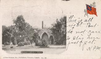 Black and white postcard of a funeral home or mausoleum surrounded by trees. The caption on the ...