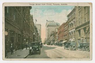 Colorized photograph of a busy downtown street in a city with skyscrapers.