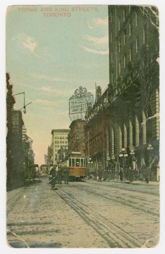 Colorized photograph of a busy downtown street in a city. Street cars on tracks.