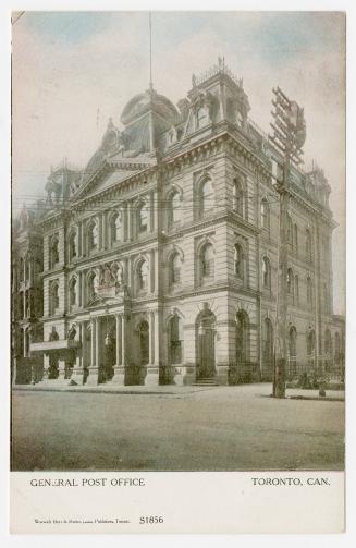 Black and white photograph of a large four story building in the Second-empire style of archite ...