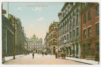 Colorized photograph of city street with tall building on either side. Large, Second Empire sty ...