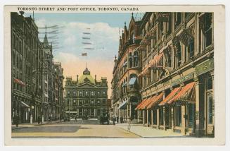 Colorized photograph of a city street with tall building on either side. Large, Second Empire s ...