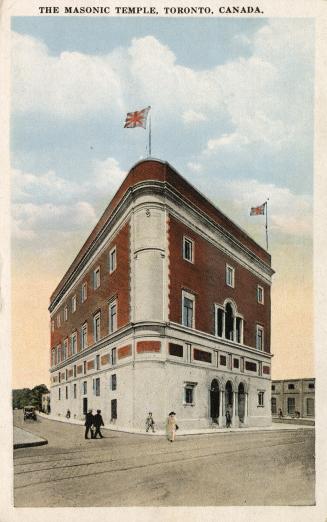 Colorized photograph of a large, three story building on a street corner.