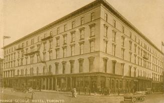 Picture of large five storey hotel on a street corner. 