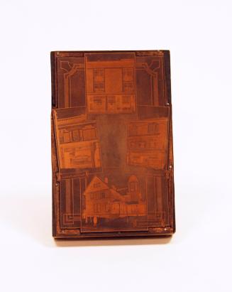 A wooden block with a metal plate on the top.