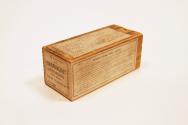 A wooden box with a handheld dating device inside. 