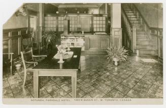 Black and white photograph of the interior of a hotel lobby.