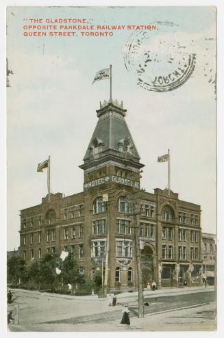 Colorized photograph of a four story hotel with a tower.