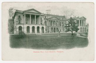 Picture of large buildings facing lawn and trees with white border. 