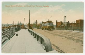 Picture of a bridge with streetcar crossing and man walking. 