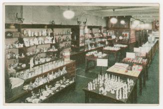 Colorized photograph of a store interior with counters and showcases.